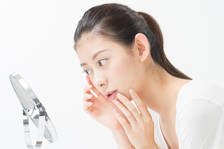 上瞼脂肪除去後、傷跡を確認する女性