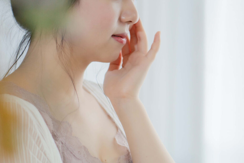 保湿クリーム、化粧水でスキンケアする女性